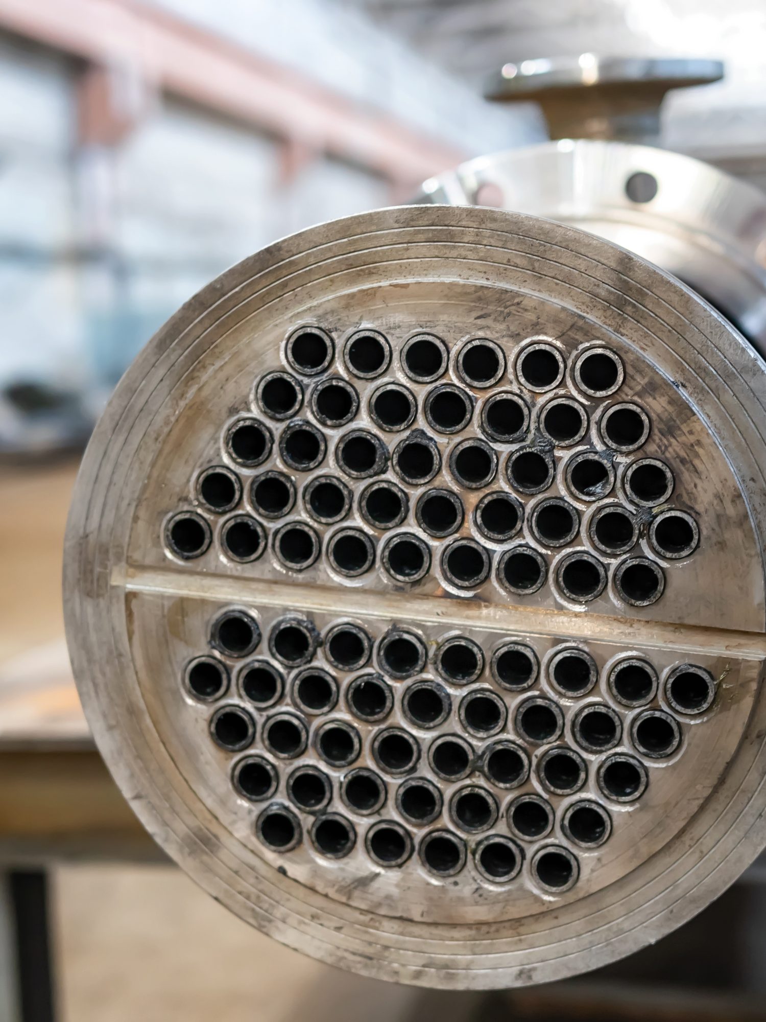 Close-up of a heat-exchanger tube-sheet face in a workshop